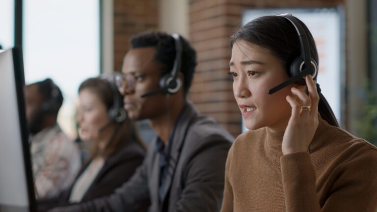 female-sales-agent-talking-phone-call-client-helping-people-customer-support-service-woman-using-headphones-give-assistance-call-center-workstation-helpdesk-scaled